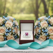 Bouquets of flowers and a ring box on a wooden surface with a blurred natural background