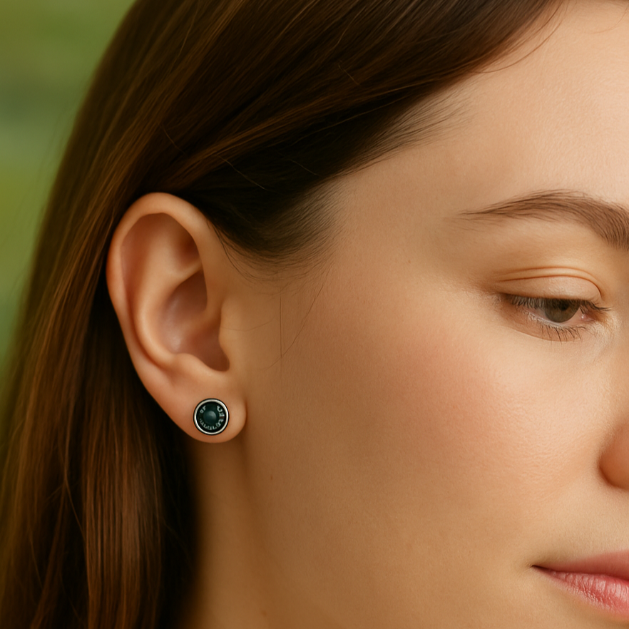 Close-up of a woman wearing a green earring with a blurred background