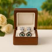 Cufflinks in a wooden box with a blurred floral background