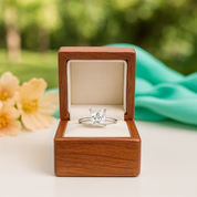 Diamond ring in a wooden box with a blurred natural background
