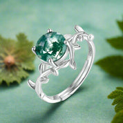 Silver ring with green moss agate stone and leaf design, labeled '925 Sterling Silver'.