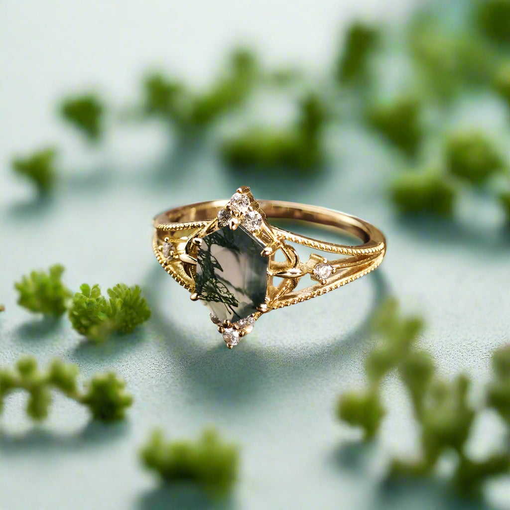 Gold ring with a green gemstone on a wooden surface