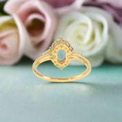 Gold ring with a blue gemstone on a light background