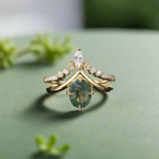 Gold ring with a green gemstone and diamond accents on a dark background