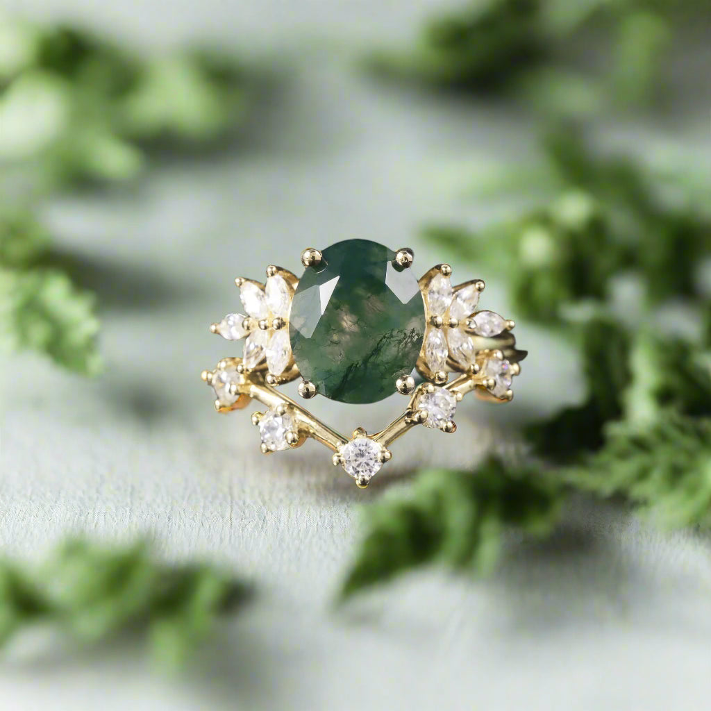 Gold ring with a green gemstone and diamond accents on a dark background