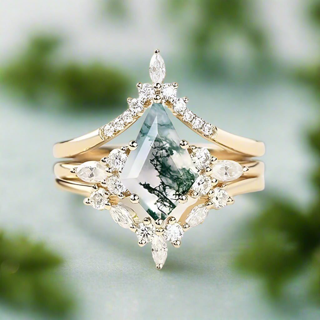 Gold ring with a green gemstone and diamond accents on a light background