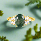Gold ring with a green gemstone and small diamonds on a white background