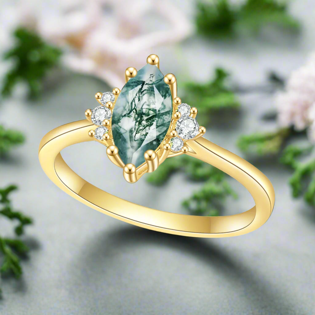 Gold ring with a green gemstone and small diamonds on a white background