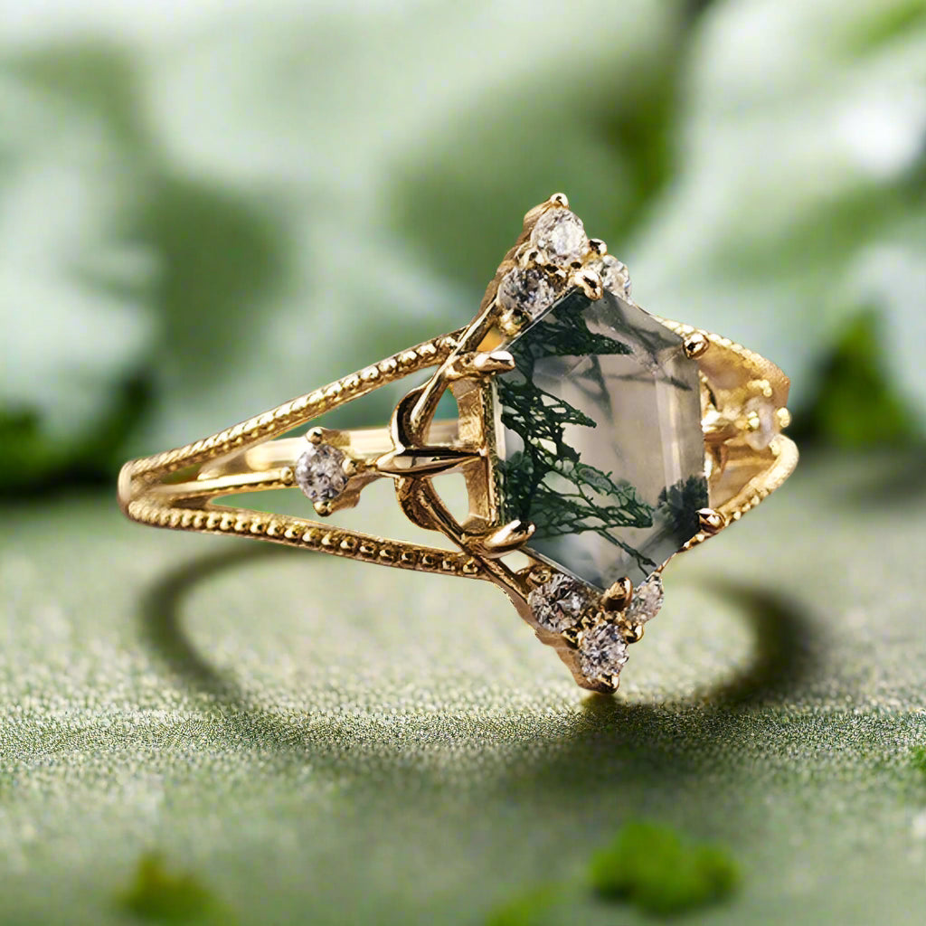 Gold ring with a green gemstone on a wooden surface