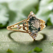 Gold ring with a green gemstone on a wooden surface