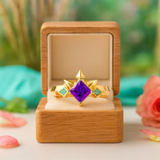Gold ring with a purple gemstone in an open wooden box on a blurred natural background