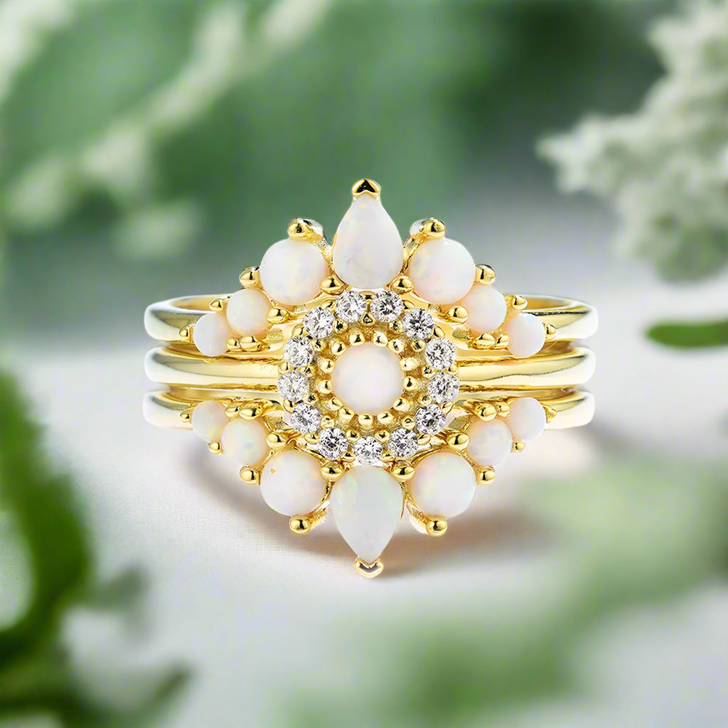 Gold ring with white stones and diamonds on a white background