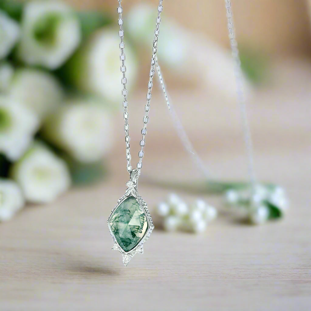 Green gemstone necklace on a light blue background.