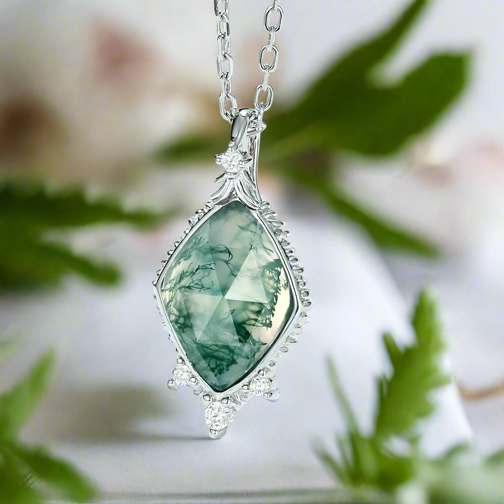Green gemstone necklace with silver chain on a light blue background