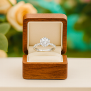 Diamond ring in a wooden box with a floral background