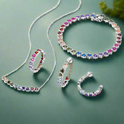 Jewelry set with multicolored gemstones on a white background
