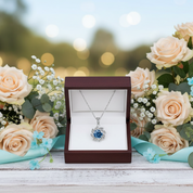 Necklace in a box with flowers on a wooden surface