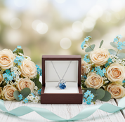 Necklace in a wooden box surrounded by flowers on a blurred background