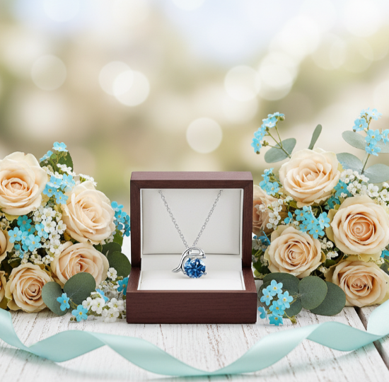 Necklace in a wooden box surrounded by flowers on a blurred background