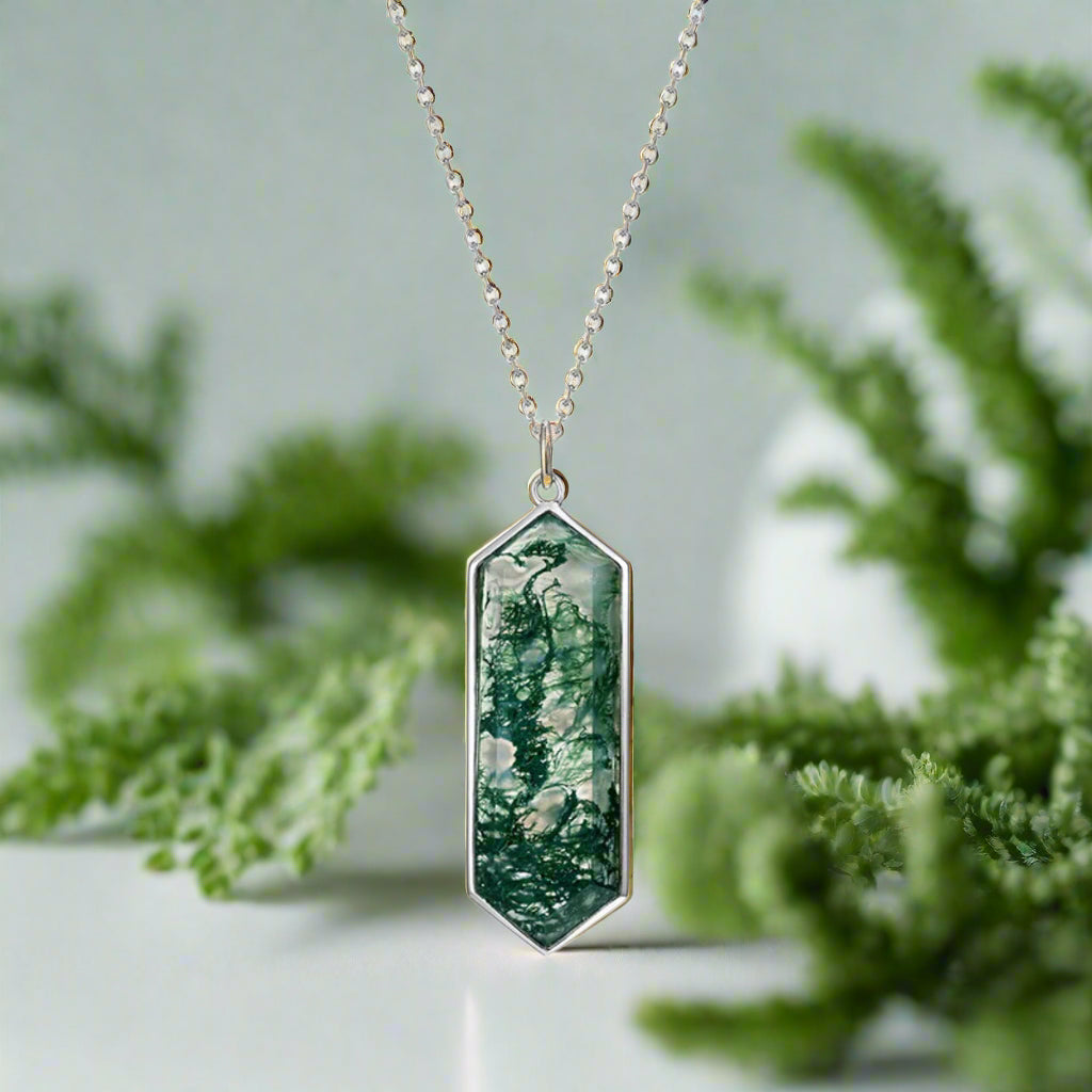 Necklace with a green pendant on a white background