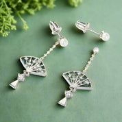 Pair of earrings with fan design on a white background