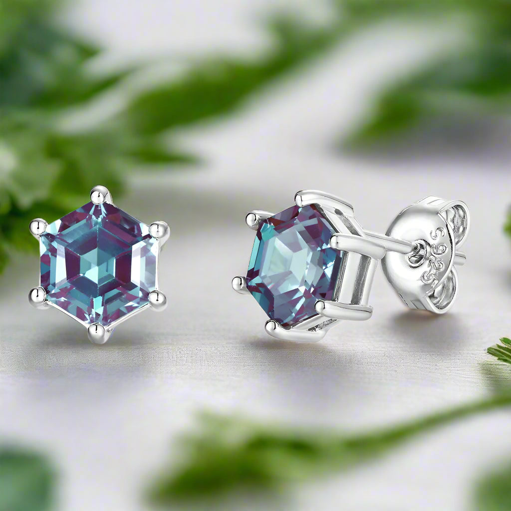 Purple gemstone stud earrings on a white background