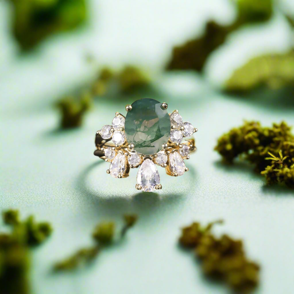 Ring with a green gemstone and diamond accents on a dark background