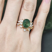 Ring with a green gemstone and gold accents on a hand