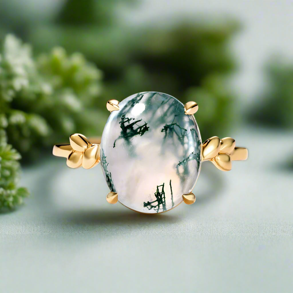 Ring with a green stone and gold accents on a light blue background