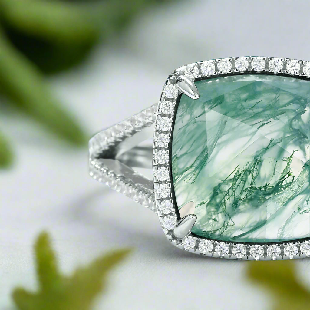 Ring with a large green gemstone and diamond-studded band on a light blue background