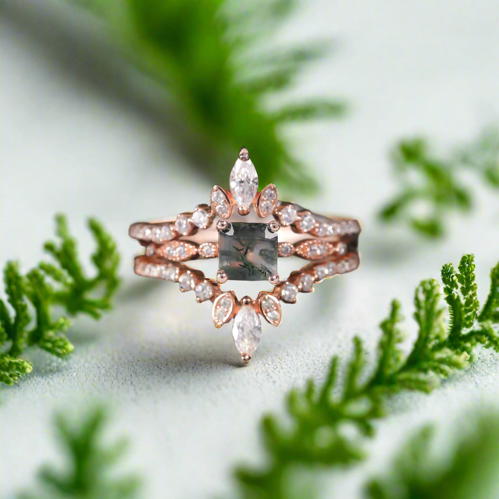Rose gold ring with a central diamond on a dark surface