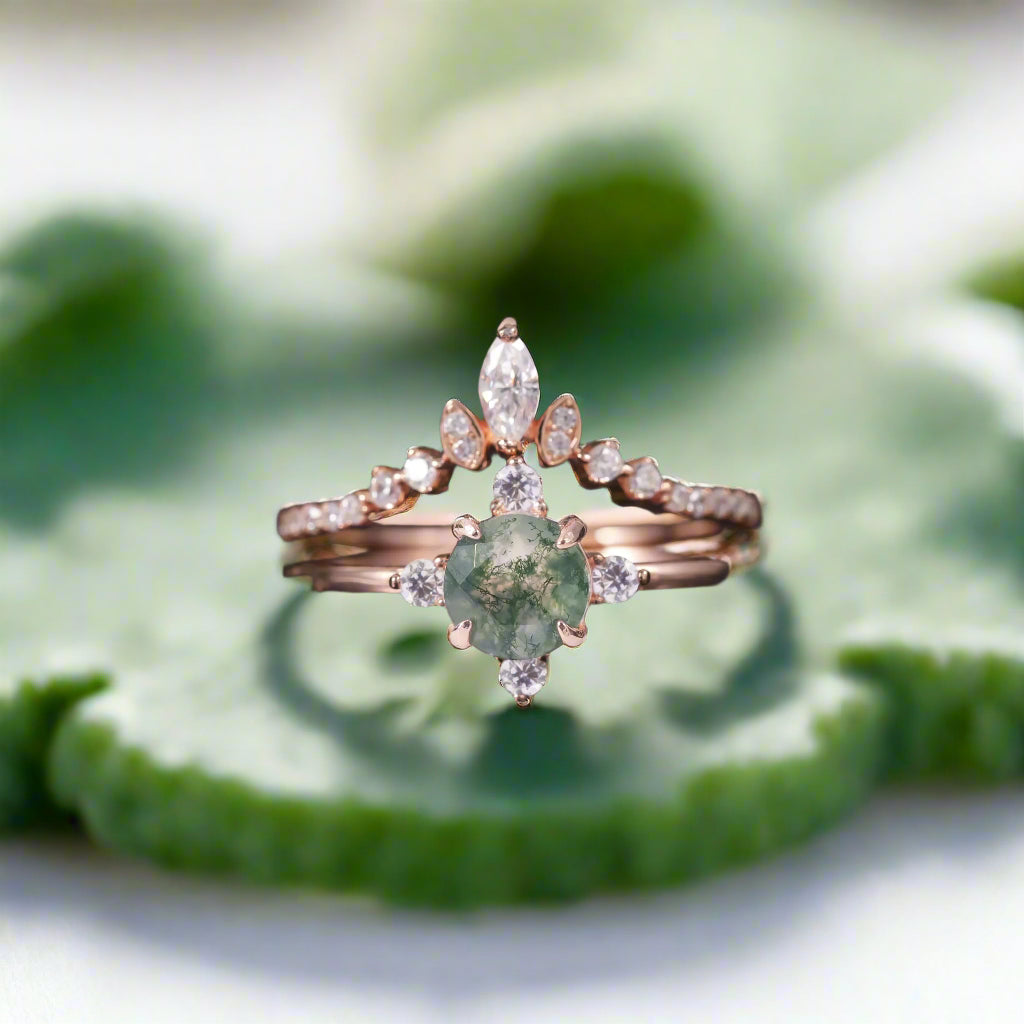 Rose gold ring with green gemstone and diamonds on a dark background
