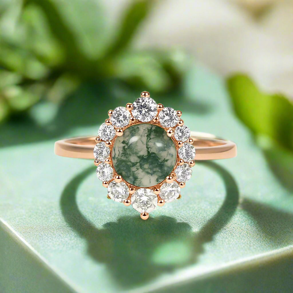 Rose gold ring with green gemstone and diamonds on a white background
