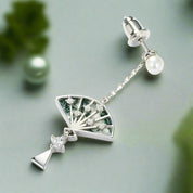 Silver earrings with fan design and pearl accents on a white background
