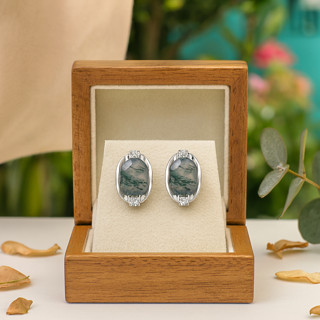 Silver earrings with greenstone stones in a wooden box with a natural background