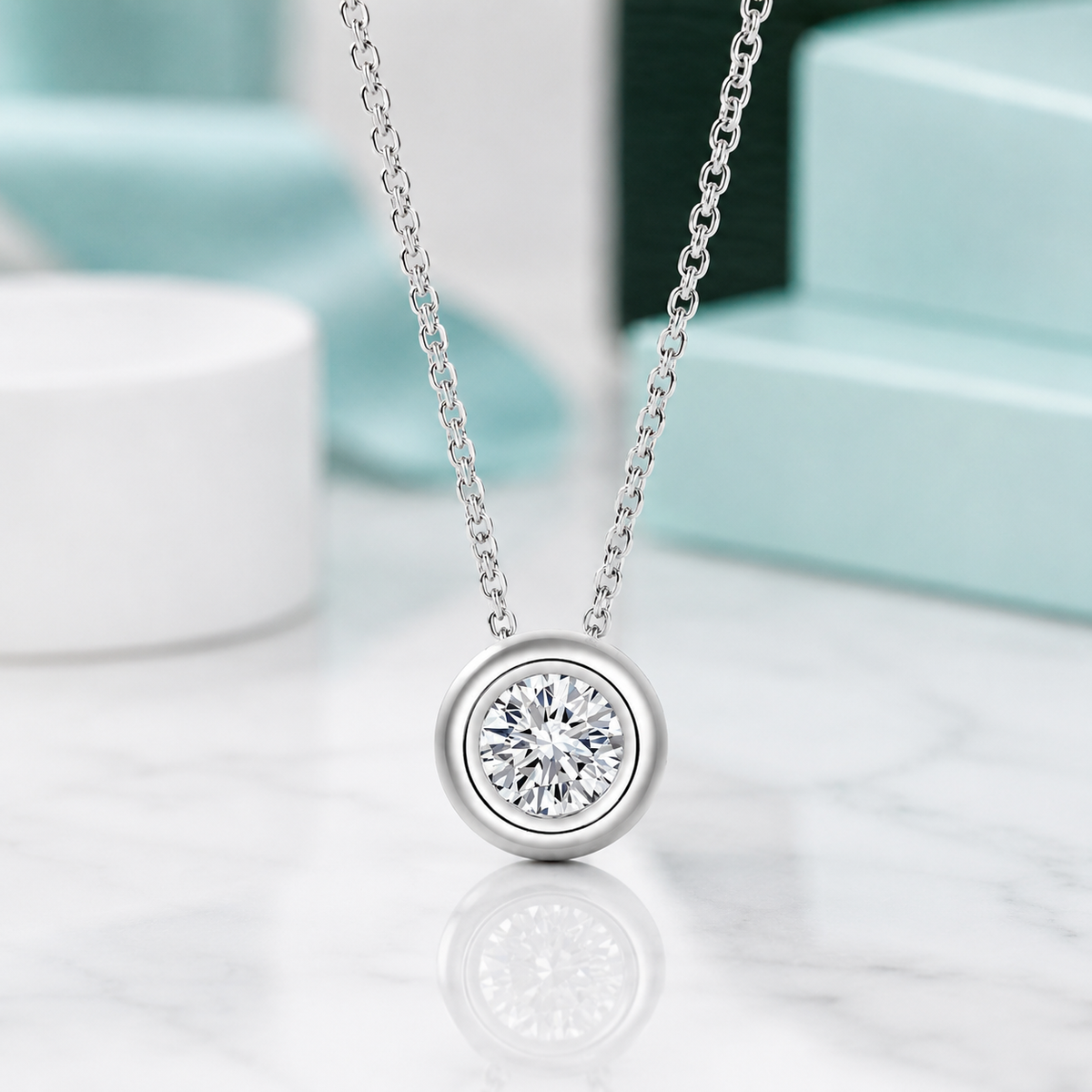 Silver necklace with a diamond pendant on a reflective surface
