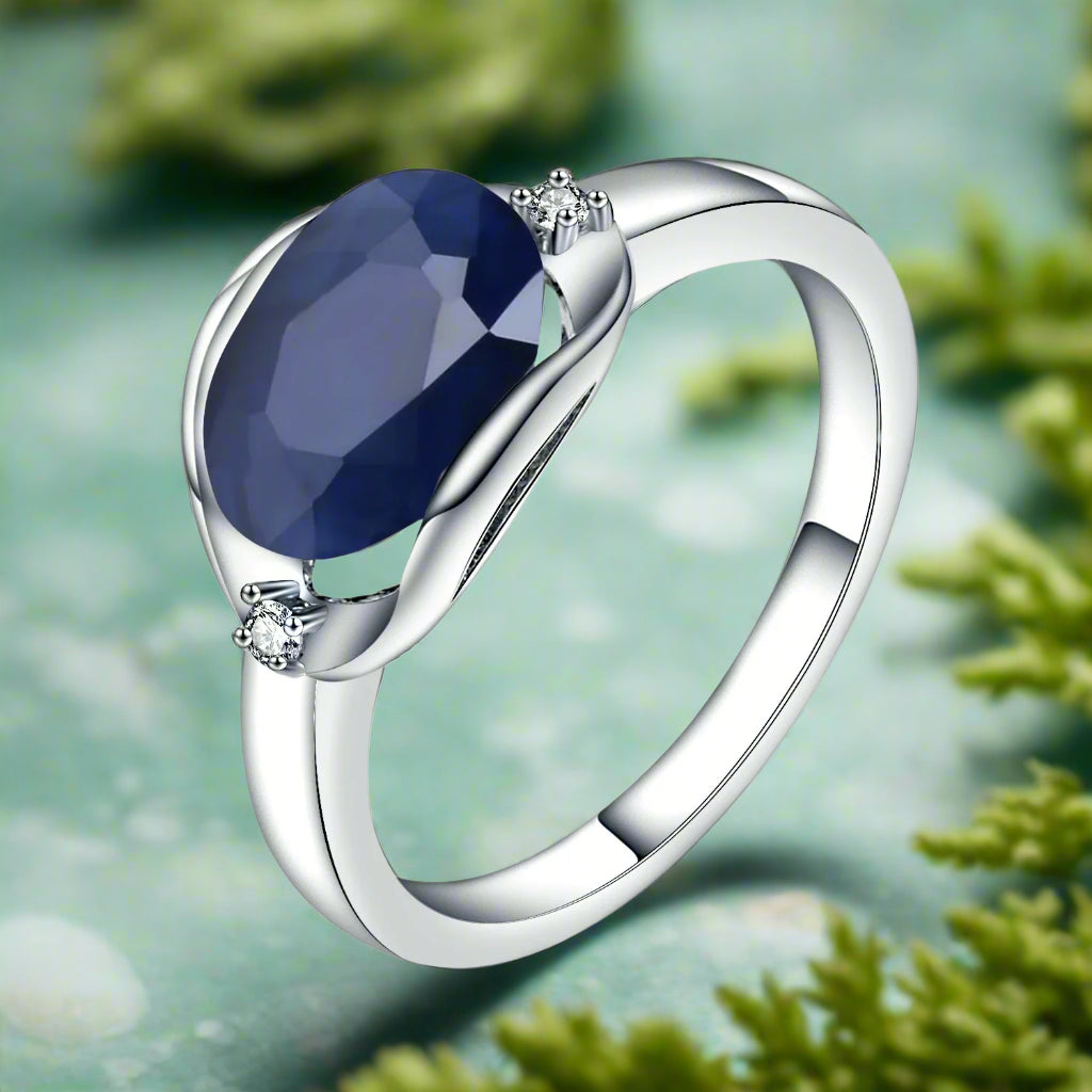 Silver ring with a blue gemstone on a white background