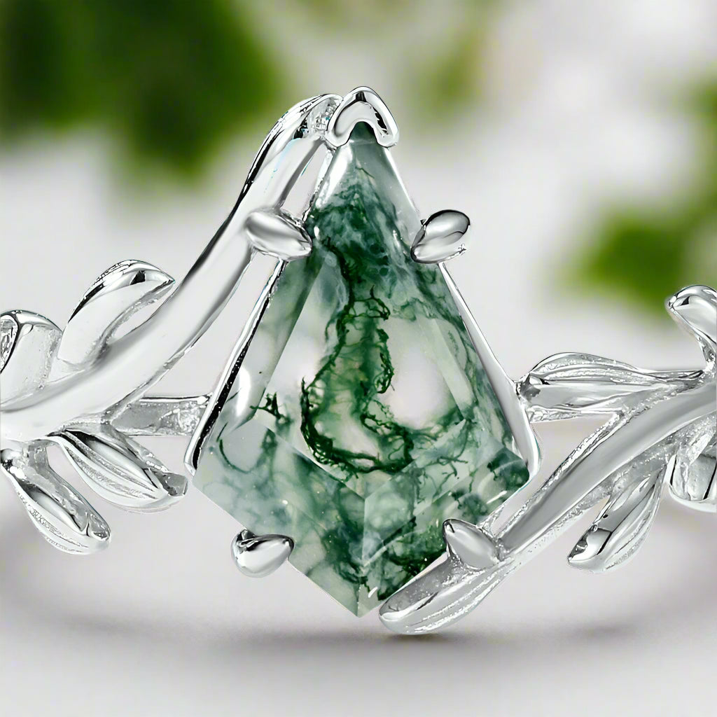 Silver ring with a green gemstone on a light blue background