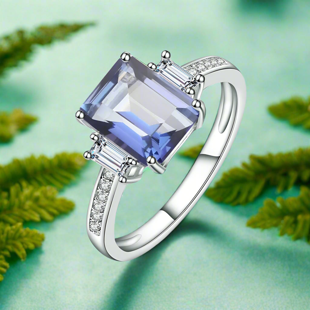 Silver ring with a large blue gemstone on a white background