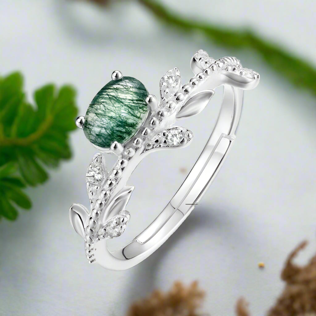 Silver ring with green moss agate and zircon stones, showing measurements and material details.