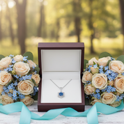 Bouquets of flowers and a necklace in a box on a wooden surface with a blurred natural background