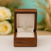 Diamond necklace in a wooden box with flowers in the background