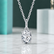 Diamond pendant on a chain against a neutral background