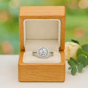 Diamond ring in a wooden box with a blurred natural background