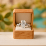 Diamond ring in a wooden box with a blurred natural background