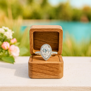 Diamond ring in a wooden box with a blurred natural background