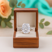 Diamond ring in a wooden box with flowers in the background
