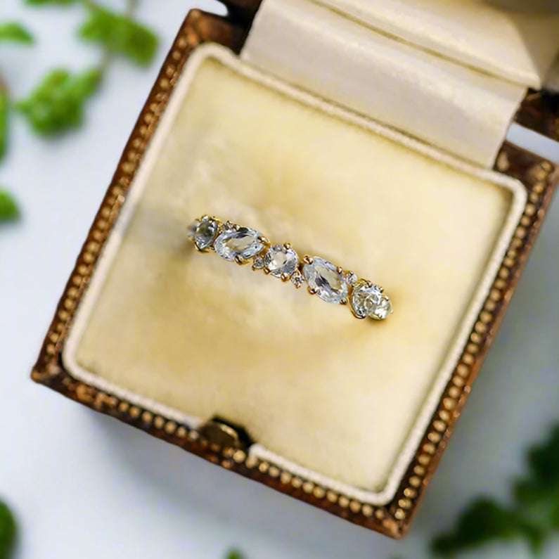 Diamond ring in an open jewelry box on a wooden surface