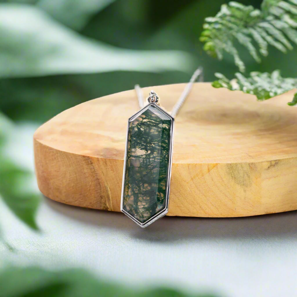Geometric pendant on a wooden block with a natural background