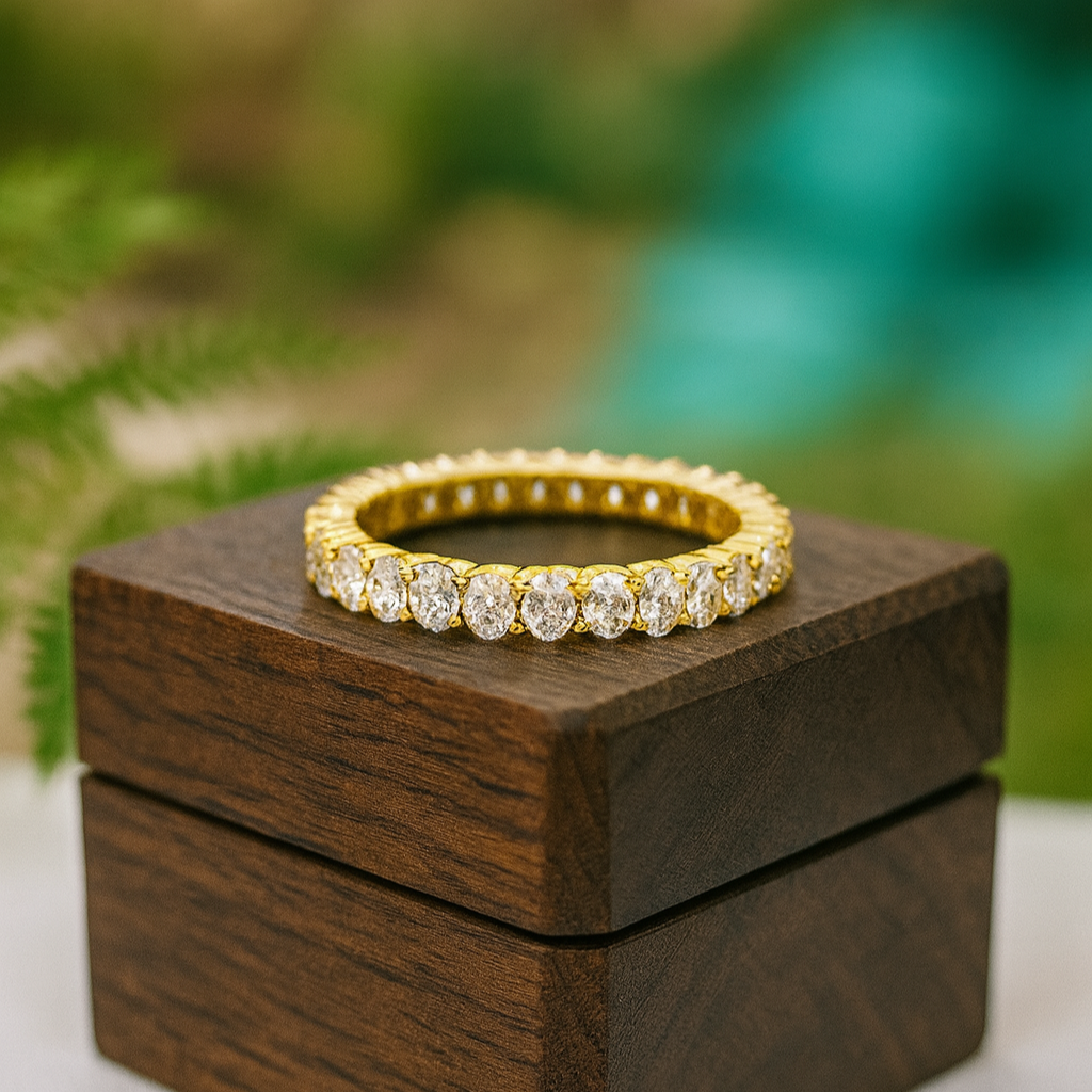 Gold and diamond ring on a wooden box with a blurred green background